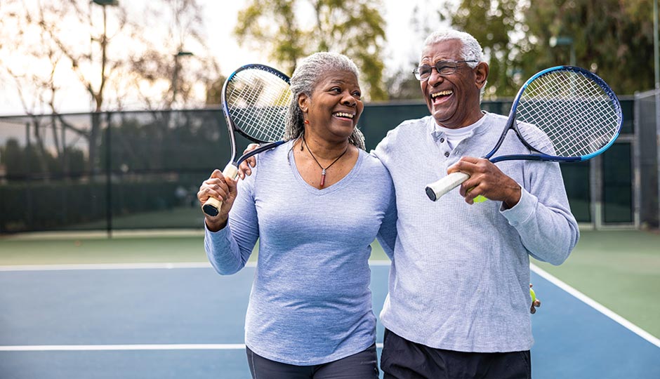 Adults playing tennis